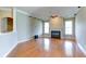 Bright living room with hardwood floors, a fireplace with a green marble hearth, and many windows at 5345 Glenhaven Dr, Cumming, GA 30041
