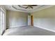 Large main bedroom featuring neutral carpet, a ceiling fan and access to the bathroom at 5345 Glenhaven Dr, Cumming, GA 30041