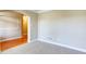 Carpeted room with white trim, with view to wooden floors and neutral walls in adjacent room at 5345 Glenhaven Dr, Cumming, GA 30041