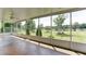Covered screened in porch with ceiling fans overlooks a large lawn and landscaped yard at 5345 Glenhaven Dr, Cumming, GA 30041