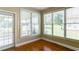 Cozy sunroom featuring hardwood floors, an exterior door, and multiple windows for enjoying the backyard view at 5345 Glenhaven Dr, Cumming, GA 30041