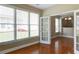 Sunroom featuring hardwood floors, white doors, and bright windows that offer views into an adjacent room at 5345 Glenhaven Dr, Cumming, GA 30041