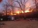 Backyard shed featuring the sunset in the background and outdoor seating at 969 Golden Meadows Ln, Loganville, GA 30052