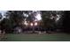 Wood shed and outdoor seating nestled among trees and a beautiful backyard sunset at 969 Golden Meadows Ln, Loganville, GA 30052