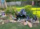 Backyard pond with fountain, aquatic plants, and decorative statues surrounded by grass at 969 Golden Meadows Ln, Loganville, GA 30052