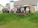 Outdoor entertaining space featuring patio, gazebo, outdoor kitchen and well-manicured lawn at 969 Golden Meadows Ln, Loganville, GA 30052