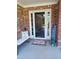 Cozy front porch with bench and 'Home Sweet Home' sign at 969 Golden Meadows Ln, Loganville, GA 30052