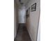 Hallway featuring wood floors, white walls, and decorative wall art; in need of repair at 969 Golden Meadows Ln, Loganville, GA 30052