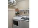Functional laundry room featuring a modern washer, dryer, and ample shelving for storage at 969 Golden Meadows Ln, Loganville, GA 30052