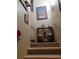 View of the staircase with wooden steps, metal handrails, and display shelf with decorative footballs at 969 Golden Meadows Ln, Loganville, GA 30052
