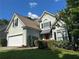 Charming home with a manicured lawn, stucco exterior, and a two car garage at 1469 Crescent Walk, Decatur, GA 30033