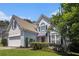 Charming two-story home with a well-maintained lawn, a two-car garage, and mature trees at 1469 Crescent Walk, Decatur, GA 30033