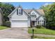 Charming two-story home with a well-maintained lawn, a two-car garage, and mature trees at 1469 Crescent Walk, Decatur, GA 30033