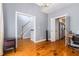 Spacious living room featuring hardwood floors, grey walls, and views into kitchen and foyer at 1469 Crescent Walk, Decatur, GA 30033