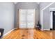 Well-lit living room with hardwood floors, neutral paint, and large windows at 1469 Crescent Walk, Decatur, GA 30033