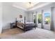Spacious main bedroom with a tray ceiling, large windows, and neutral carpet at 1469 Crescent Walk, Decatur, GA 30033