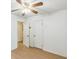 Bedroom with wood flooring, ceiling fan, and a closet and doorway at 364 Stafford Sw St, Marietta, GA 30064