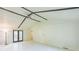 Open living room with beamed ceilings, ceiling fan, tile flooring, and access to the backyard at 364 Stafford Sw St, Marietta, GA 30064