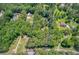 Aerial view of the property highlighting the boundaries, dense trees, and surrounding landscape at 5491 Hiram Rd, Powder Springs, GA 30127