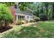 Backyard featuring a brick chimney and landscaped area, providing a serene outdoor space at 5491 Hiram Rd, Powder Springs, GA 30127