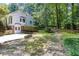 Backyard features a well-maintained lawn and landscaped area, offering privacy and a garden at 5491 Hiram Rd, Powder Springs, GA 30127