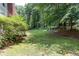 Backyard featuring lush landscaping, providing ample shade and a serene outdoor space at 5491 Hiram Rd, Powder Springs, GA 30127