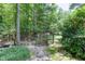 Backyard features a secure wood fence and gate, offering privacy, lush vegetation and manicured lawn at 5491 Hiram Rd, Powder Springs, GA 30127