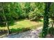 View of a beautifully maintained backyard with a wooden fence and verdant landscaping at 5491 Hiram Rd, Powder Springs, GA 30127