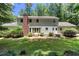 Backyard featuring a brick chimney and landscaped area, providing a serene outdoor space at 5491 Hiram Rd, Powder Springs, GA 30127