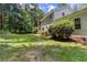 Expansive backyard featuring lush greenery and mature trees, offering privacy and natural beauty at 5491 Hiram Rd, Powder Springs, GA 30127