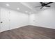 Finished basement featuring two white doors, recessed lighting, wood-style floors and ceiling fan at 5491 Hiram Rd, Powder Springs, GA 30127