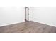 Finished basement with wood-style floors and white walls, showing an open door at 5491 Hiram Rd, Powder Springs, GA 30127