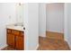 Bathroom featuring a single sink vanity with cabinet storage and tile floors at 5491 Hiram Rd, Powder Springs, GA 30127