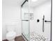 Modern bathroom with a glass shower enclosure, gray and white tile floor, matte black fixtures, and a toilet at 5491 Hiram Rd, Powder Springs, GA 30127