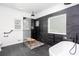 Stunning bathroom featuring a soaking tub, glass enclosed shower, and black slate tile at 5491 Hiram Rd, Powder Springs, GA 30127