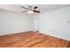 Spacious bedroom with wood flooring, ceiling fan, and natural light at 5491 Hiram Rd, Powder Springs, GA 30127