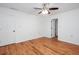 An empty bedroom shows wood-look floors, a ceiling fan, and neutral walls with a doorway entrance at 5491 Hiram Rd, Powder Springs, GA 30127