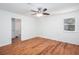 Bright bedroom features a ceiling fan, wood-look flooring, and a window with natural light at 5491 Hiram Rd, Powder Springs, GA 30127
