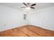 Bright bedroom featuring wood-look floors, a window, and closet space, and white walls at 5491 Hiram Rd, Powder Springs, GA 30127