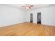 Bright bedroom featuring hardwood floors, neutral paint, access to a bathroom, and a ceiling fan at 5491 Hiram Rd, Powder Springs, GA 30127