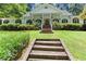 Inviting home featuring lush landscaping, a charming porch, and a well-maintained front yard at 5491 Hiram Rd, Powder Springs, GA 30127