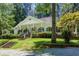 Charming home with lush landscaping, a covered porch, and classic architectural details at 5491 Hiram Rd, Powder Springs, GA 30127