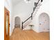 Bright foyer featuring hardwood floors, staircase, and arched doorways at 5491 Hiram Rd, Powder Springs, GA 30127