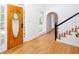 Light-filled foyer with hardwood floors, staircase, and decorative front door at 5491 Hiram Rd, Powder Springs, GA 30127