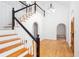 Elegant foyer with wood floors, staircase, and arches leading to other rooms at 5491 Hiram Rd, Powder Springs, GA 30127