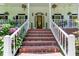 Inviting brick steps lead to the front door of this home with lush landscaping at 5491 Hiram Rd, Powder Springs, GA 30127