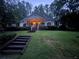 Charming home featuring a welcoming front porch with steps, set amidst lush greenery and a well-manicured lawn at 5491 Hiram Rd, Powder Springs, GA 30127