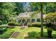 Charming home with a welcoming front porch and landscaped yard with mature plantings at 5491 Hiram Rd, Powder Springs, GA 30127