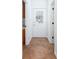 Hallway with a back door and neutral tile flooring leading to the kitchen at 5491 Hiram Rd, Powder Springs, GA 30127