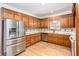 Spacious kitchen with stainless steel refrigerator and wooden cabinets at 5491 Hiram Rd, Powder Springs, GA 30127